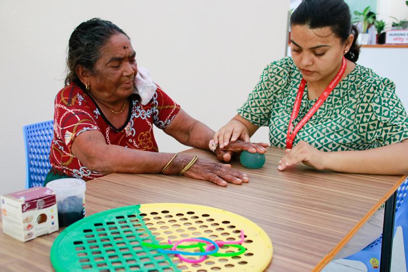 Dorothy Das Pariyar during hand training with a leprosy patient