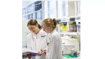 Dr. Engeland (MD PhD) and Dr. Veinalde (PhD) discuss results in the research laboratory at the National Center for Tumor Diseases.